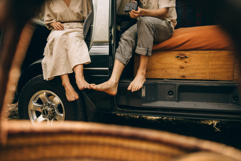 Barefoot couple sitting in their campervan during a cinematic Sunshine Coast storytelling session. A candid, romantic van-life moment in the hinterland forest, created for adventurous couples who love nature, slow living, and authentic photography on the Sunshine Coast.