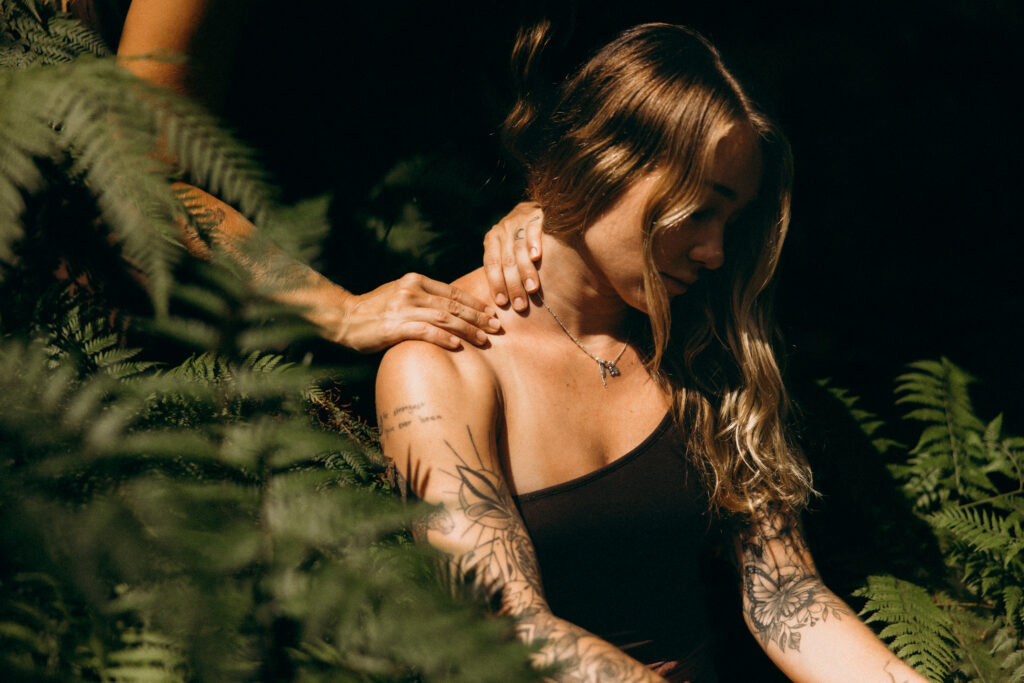 Sunshine Coast brand photographer captures natural portrait of massage therapist with ferns for wellness brand photography