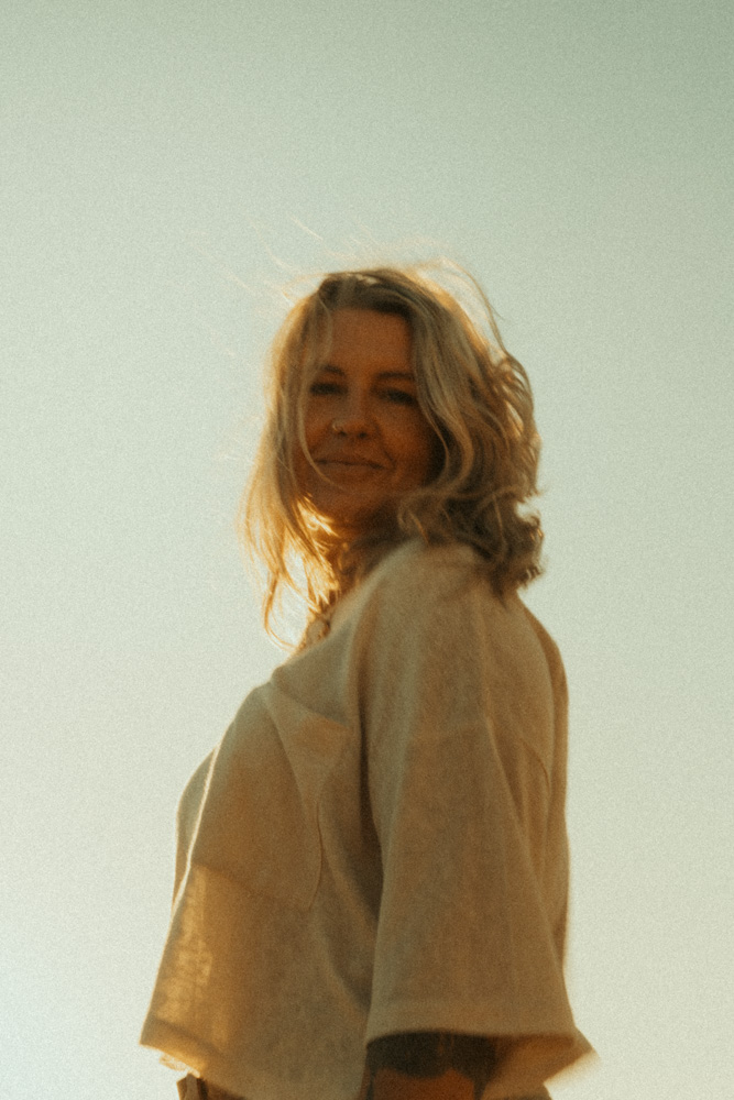 Film style image of Photographer behind Nicci K Photography, relaxed portrait 
