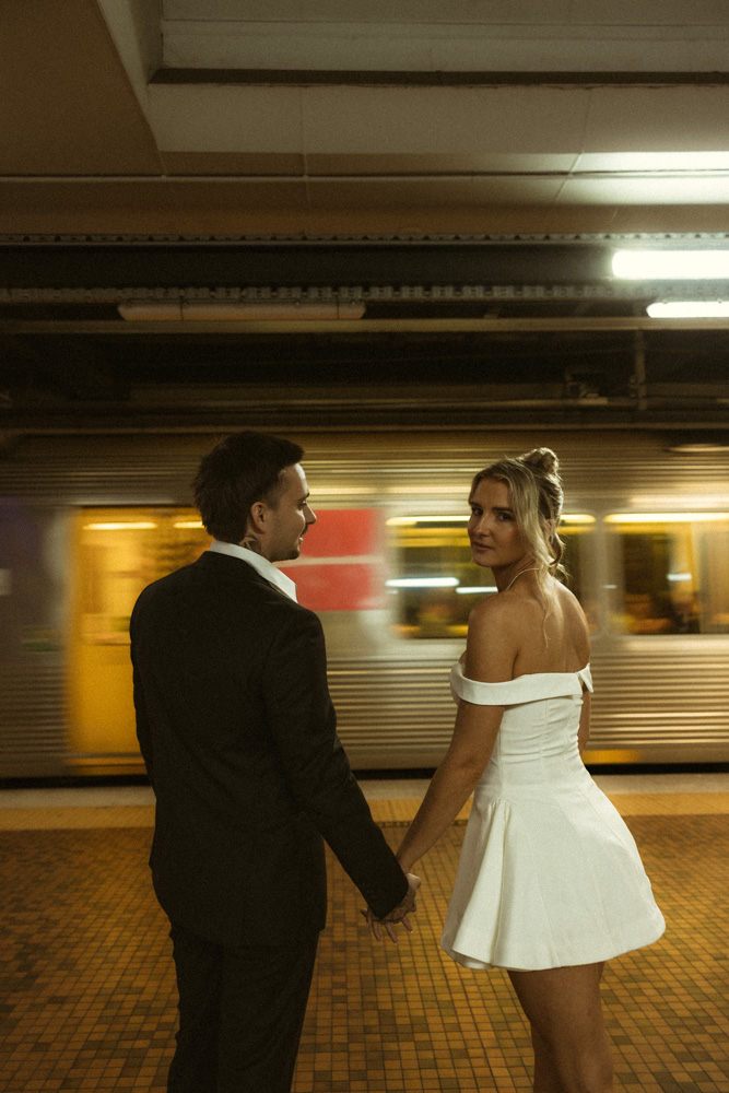 Bride and Groom holding hands in the train station at Brisbane during a city elopement