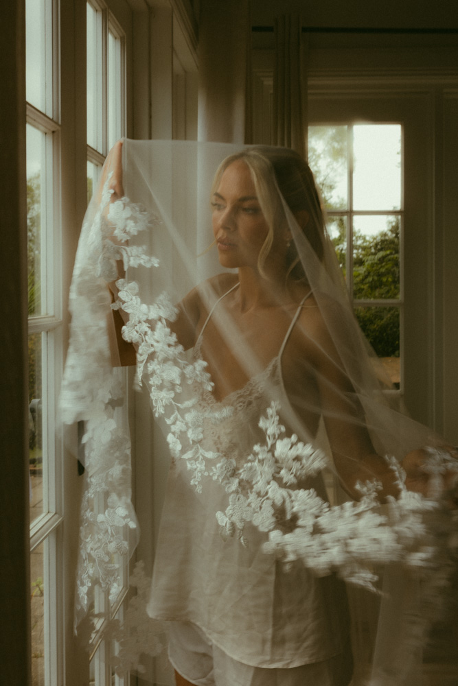 creative motion blur of bride under her veil whilst getting ready 