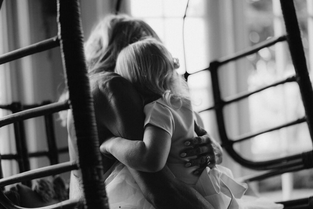emotive black and white image of bride higging her dughter