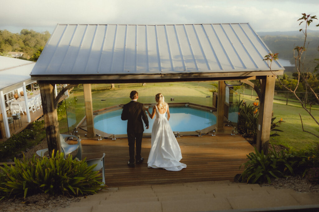 couple walking in front of the plunge pool overlooking the hinterland at Montville - stormy sky