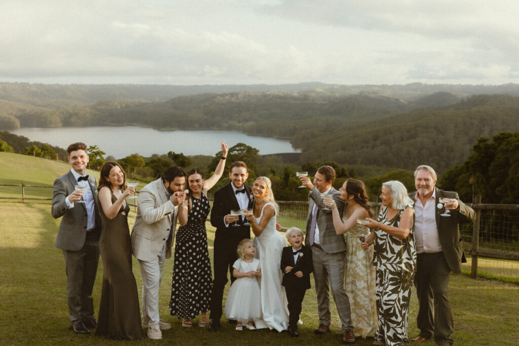 Guests and bride and groom toasting champayne 