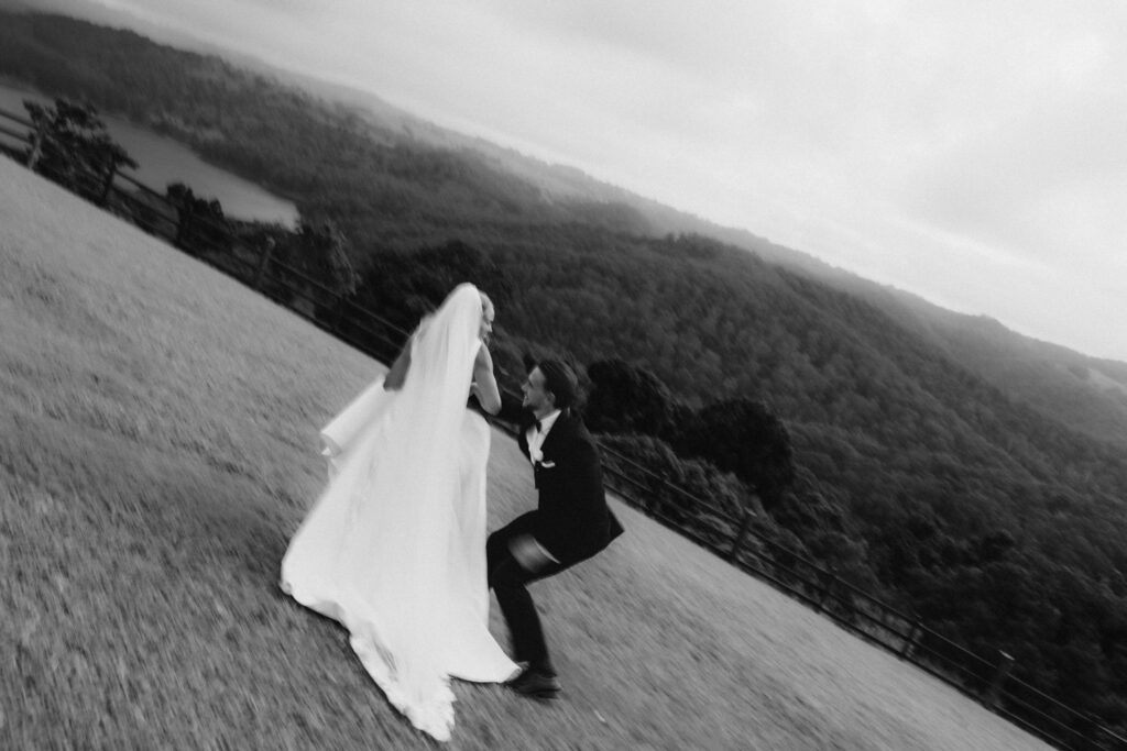 motion blur black and white image of groom chasing wife
