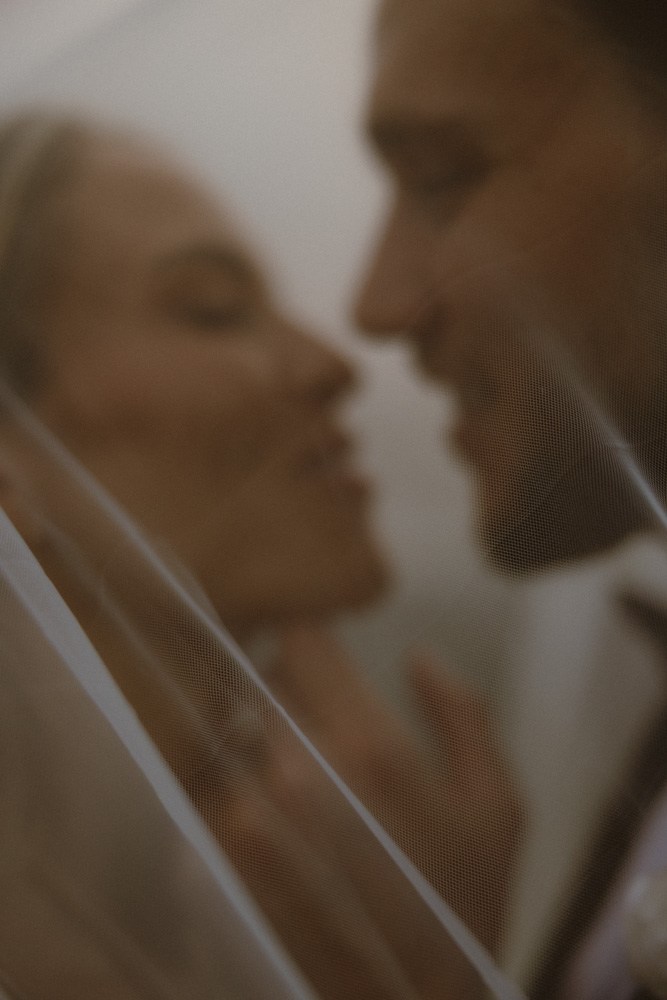 Slightly out of focus shot of couple almost kissing at their elopement