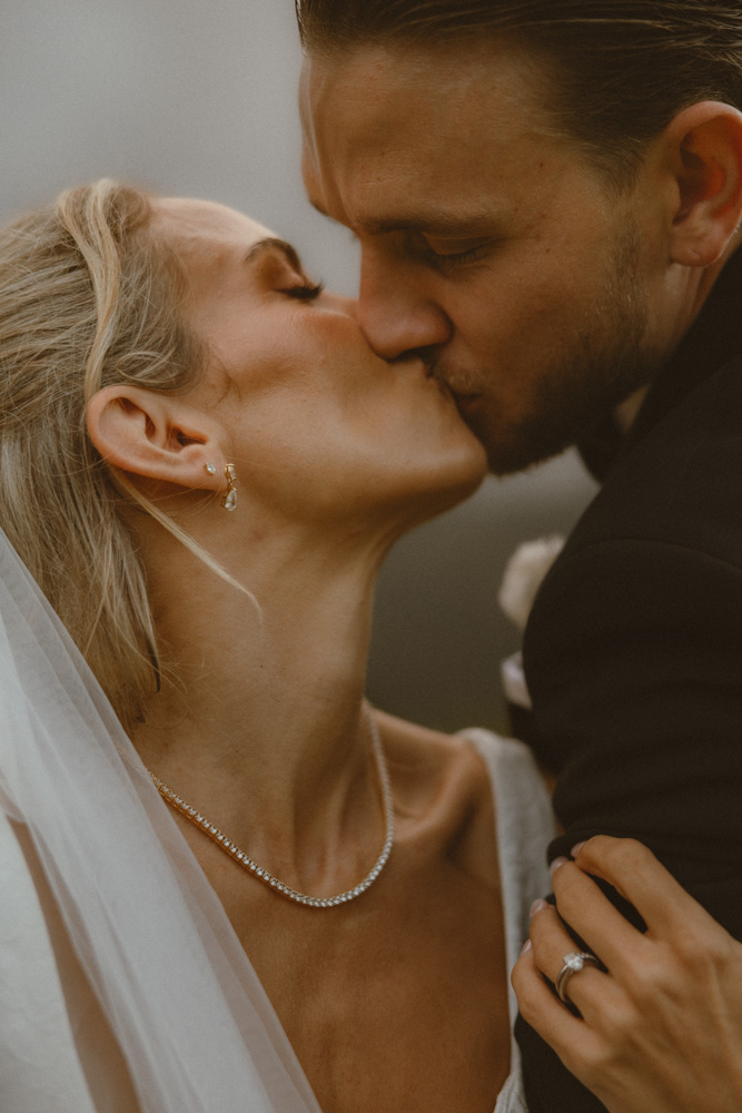 Bride and groom sharing an kiss - close up image